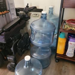 Five 3 gallon plastic water bottles and two free rechargeable pumps