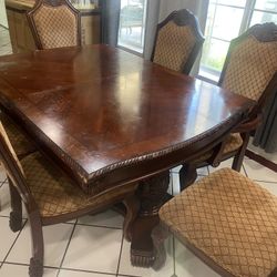 Wood table With 6 chiars And An Extension In The Middle