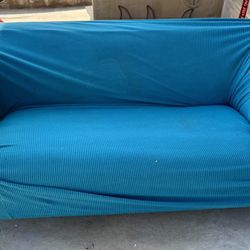 Comfortable Blue Sofa With Fitted Cover