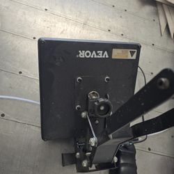 Heat PressThe image shows a heat press, which is a machine used to transfer designs onto various materials using heat and pressure. Here's a breakdown