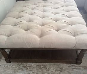 Ottoman with tan fabric  top
