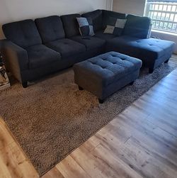 Gray sectional sofa with chaise and ottoman.