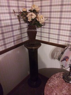 Brown pedestal with metal vase flower arraignment