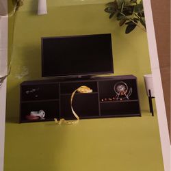Black Finish Holds A Flat- Panel Tv
