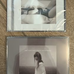 Taylor Swift, tortured poets department, CDs. The manuscript edition and the albatross edition with bonus items.