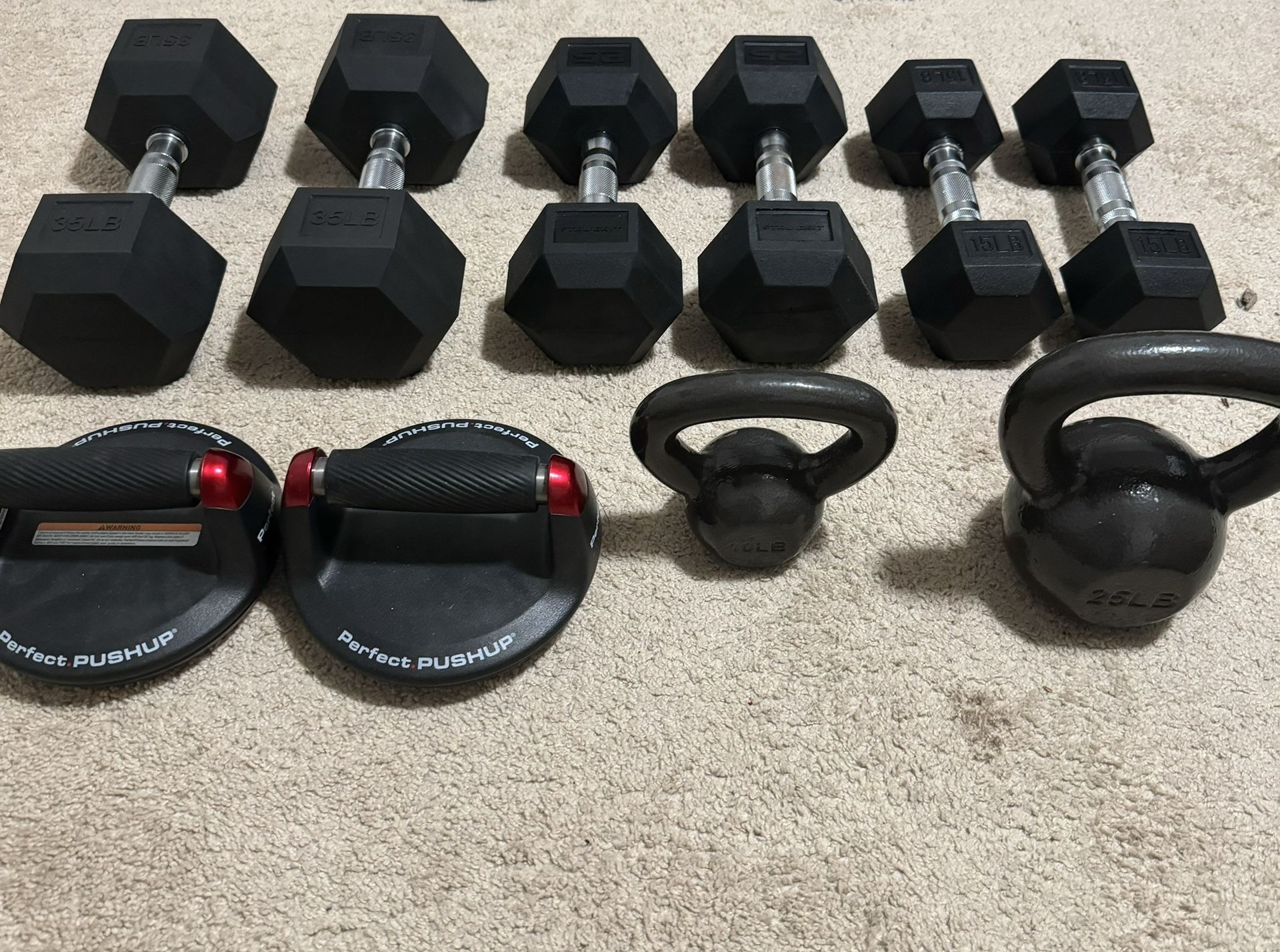 Lot of dumbbells and kettlebells