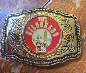 Gold tone oval commemorative belt buckle