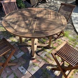48” Round teak Table And 4 Matching Folding Teak Chairs   Located in concord Recently cleaned, sanded and teak oiled Teak wood is heavy and sturdy  No