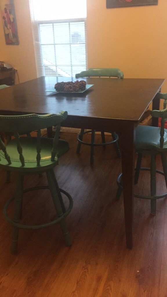 Painted brown dining room table with 4 blue bar height chairs. Perfect for THANKSGIVING!
