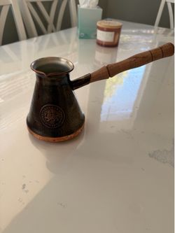handcrafted Armenian copper cezve with a wooden handle, often called a jazva