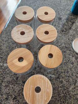 Glass tumbler with wooden lids
