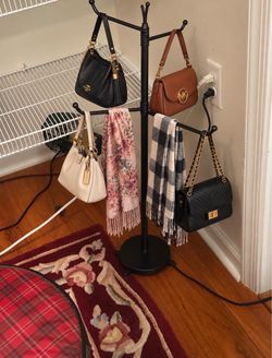 Freestanding Purse, Scarf & Hat Rack Stylish black metal freestanding display rack, approximately 45 inches tall. Great for organizing and displaying