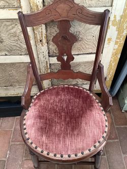 Beautiful carved Victorian pink velvet cushion chair.
