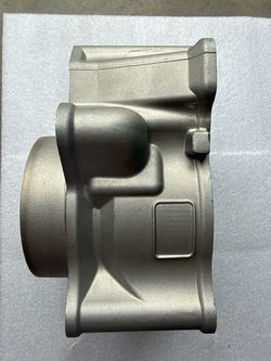 Clean silver aluminum cylinder head. This component has a bore diameter of approximately 3.75 inches. The total width is around 5.5 inches and the hei