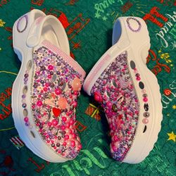 custom Crocs with various decorative charms. 