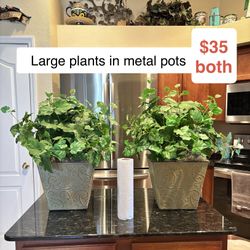 Large artificial silk potted plants in metal pots