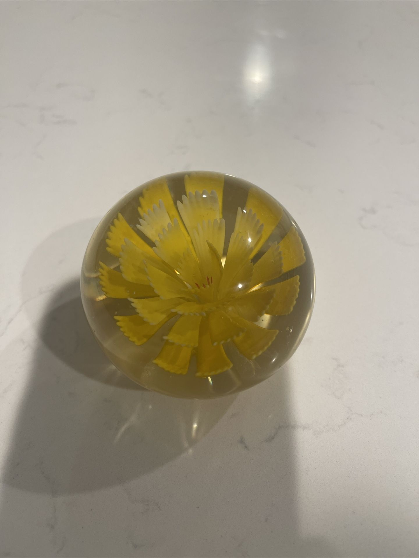 Vintage small round glass paperweight with yellow chrysanthemum