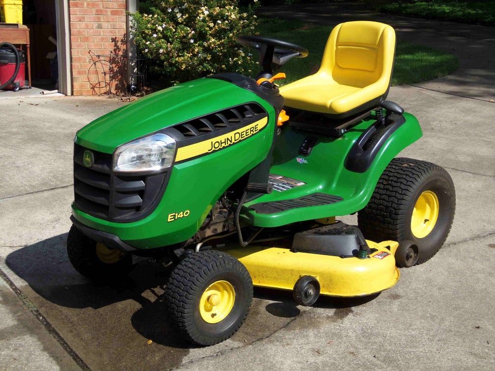 Almost new John Deere E140 riding mower only 28.1 hrs. 6yr warranty for