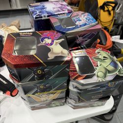 Pokemon Tin Empty Lot. Eveelutions cover arts, pickachu, etc. 10 tins and 3 lunchbox tins. 13 total.