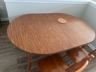 Brown wooden table with 4 chairs table-65 inches long 42 inches wide 30 inches tall