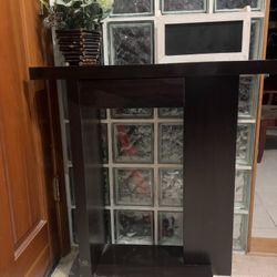 This sleek and modern dark wood console table is perfect for entryways, hallways, or living rooms. Its minimalist design features clean lines, a sturd