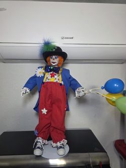 Porcelain clown doll on stand