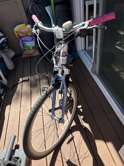 White Schwinn Cruiser Bike with pink and blue accents