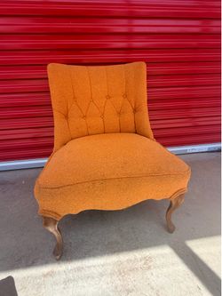 vintage orange button-tufted slipper chair