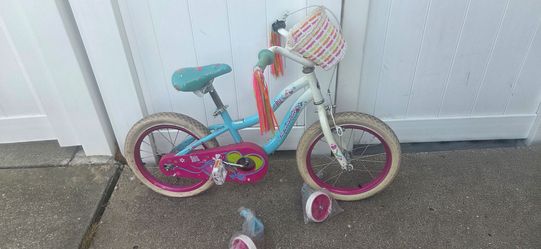 Schwinn little girl bike with training wheels.