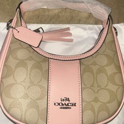 pink and tan coach shoulder purse 