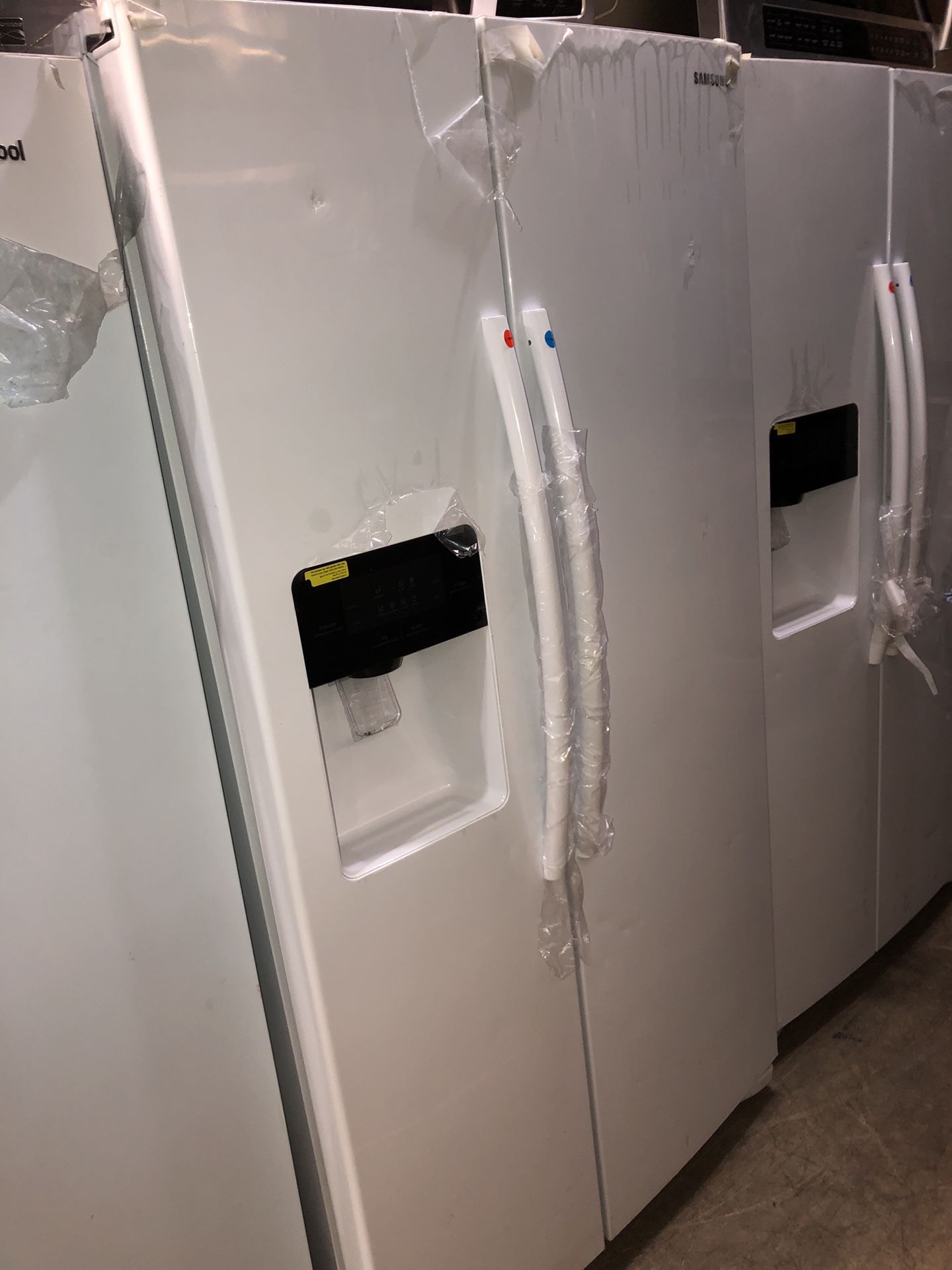 samsung white side by side fridge with water/ice dispenser
