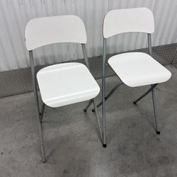 2 White Folding Chairs