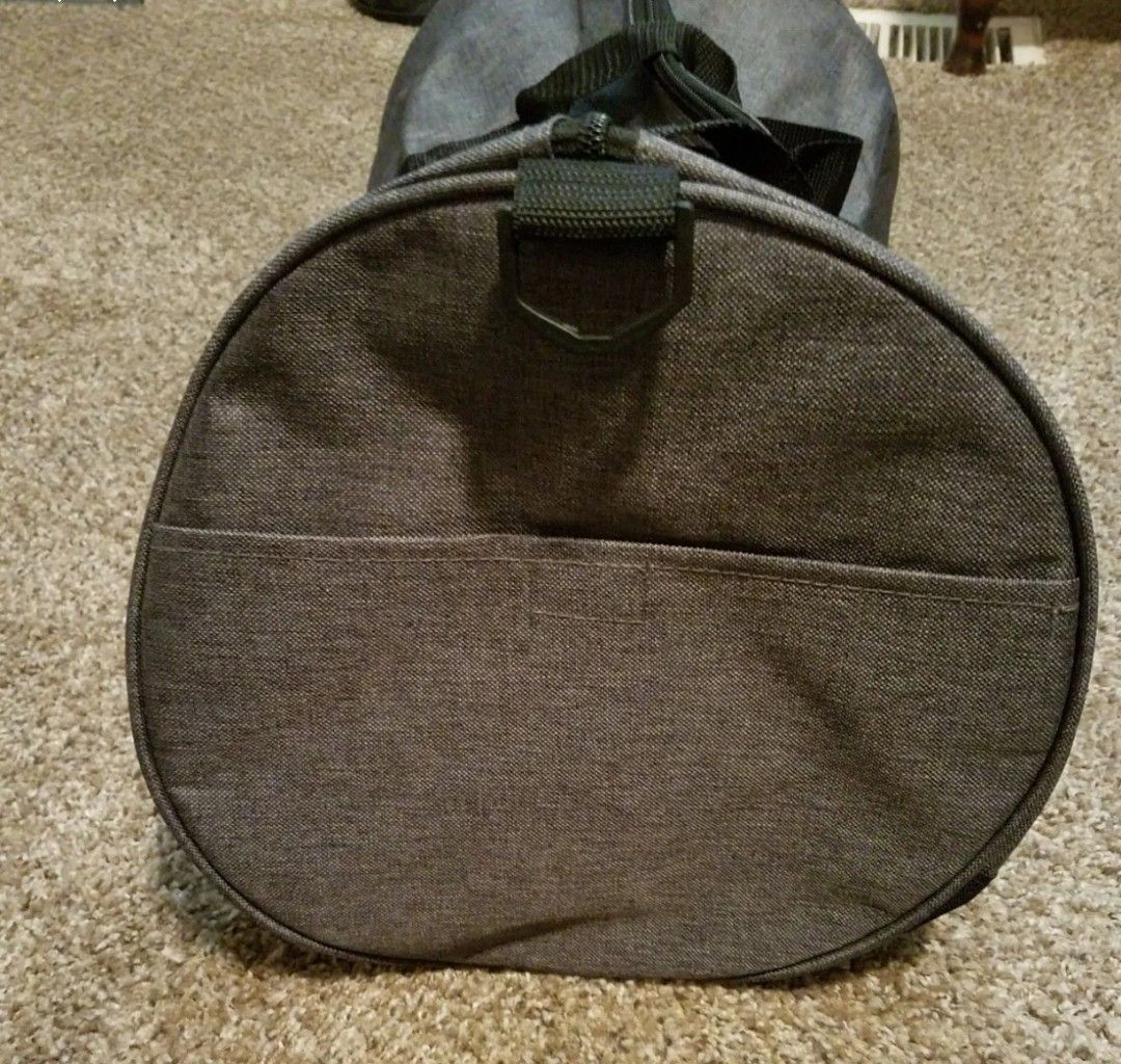 New without tags gray Duffle bag with zipper and shoulder Strap