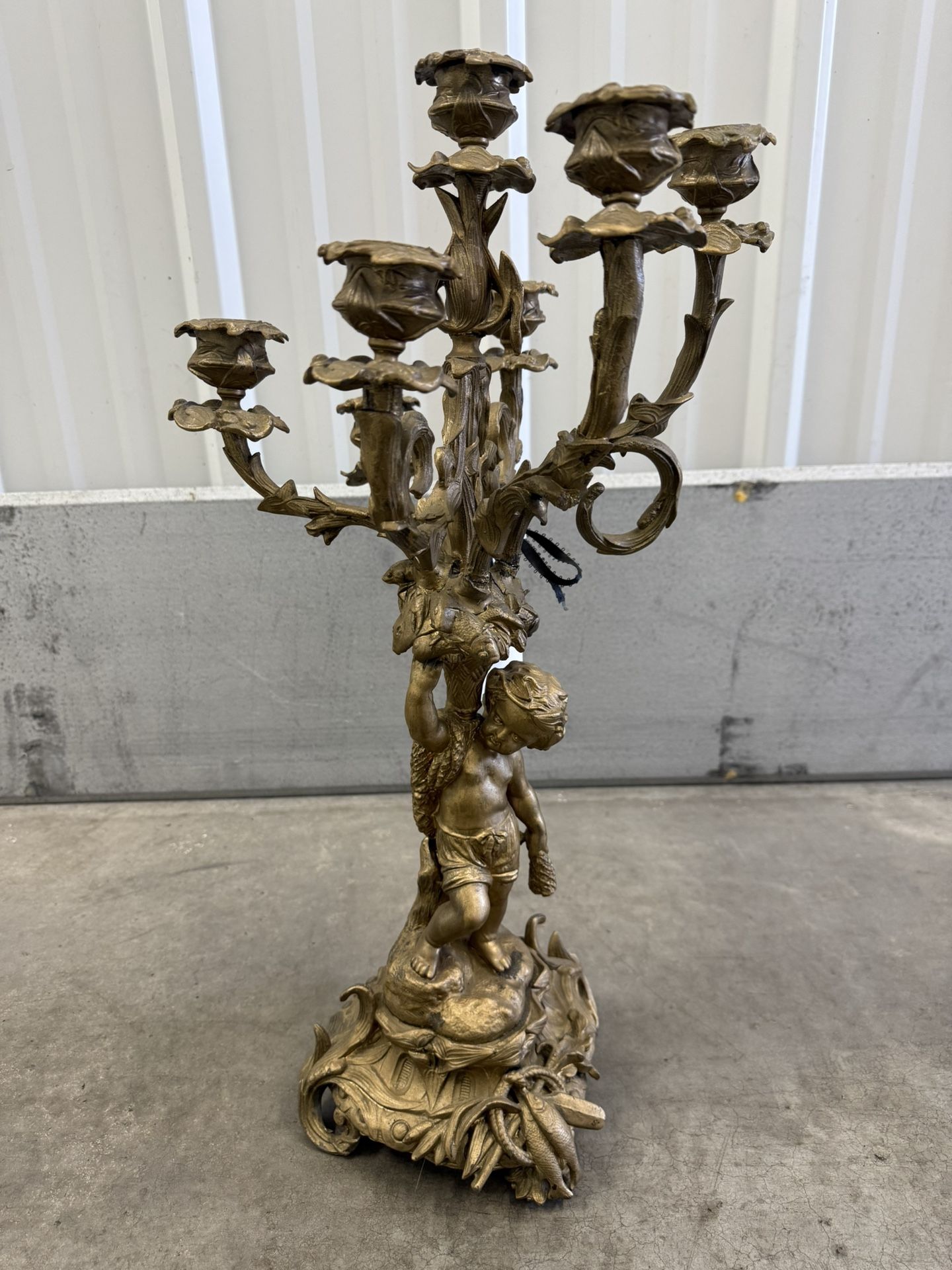 Ornate French bronze candelabra with cherub and floral motifs. Candelabras, particularly those made of bronze and in ornate styles like Louis XV, were