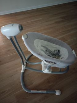 Graco DuetConnect LX baby swing and bouncer in a neutral gray color.