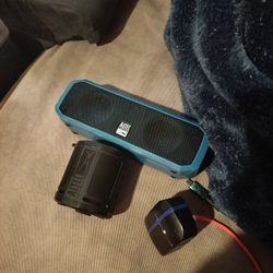 Two Waterproof Speakers And A Pair Of Earbuds