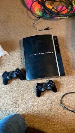 PlayStation 3 with 2 controllers and wires