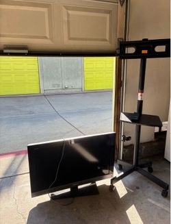Rolling tv stand with tv and remote