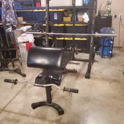 Nautilus bench press, squat rack, and pulley system.