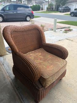 Brown Wicker Armchair with Floral Cushion