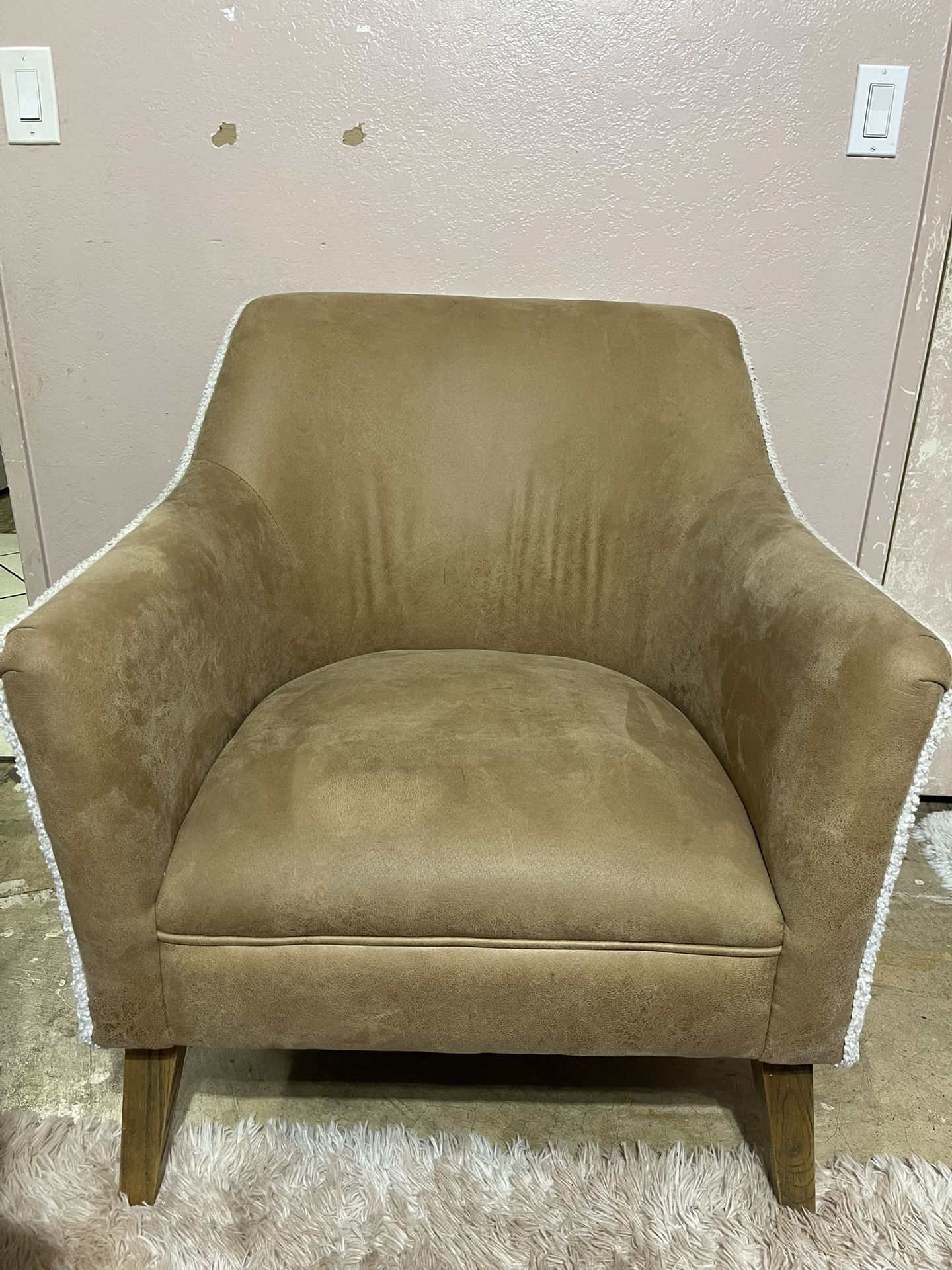 Tan suede-look accent chair with light wood legs and white trim