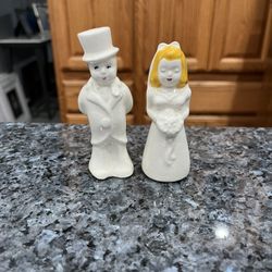 Vintage Mid century, bride and groom, salt and pepper shakers.  Size approximately bride  3 3/4 inches tall and Groom 4 1/4 inches tall.  Preowned 