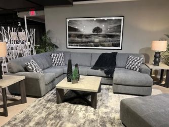 Brand New 3 Pc Grey Sectional features jumbo stitching w/cozy appeal