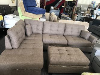 Nailhead upholstered fabric reversible sectional- brand new with ottoman