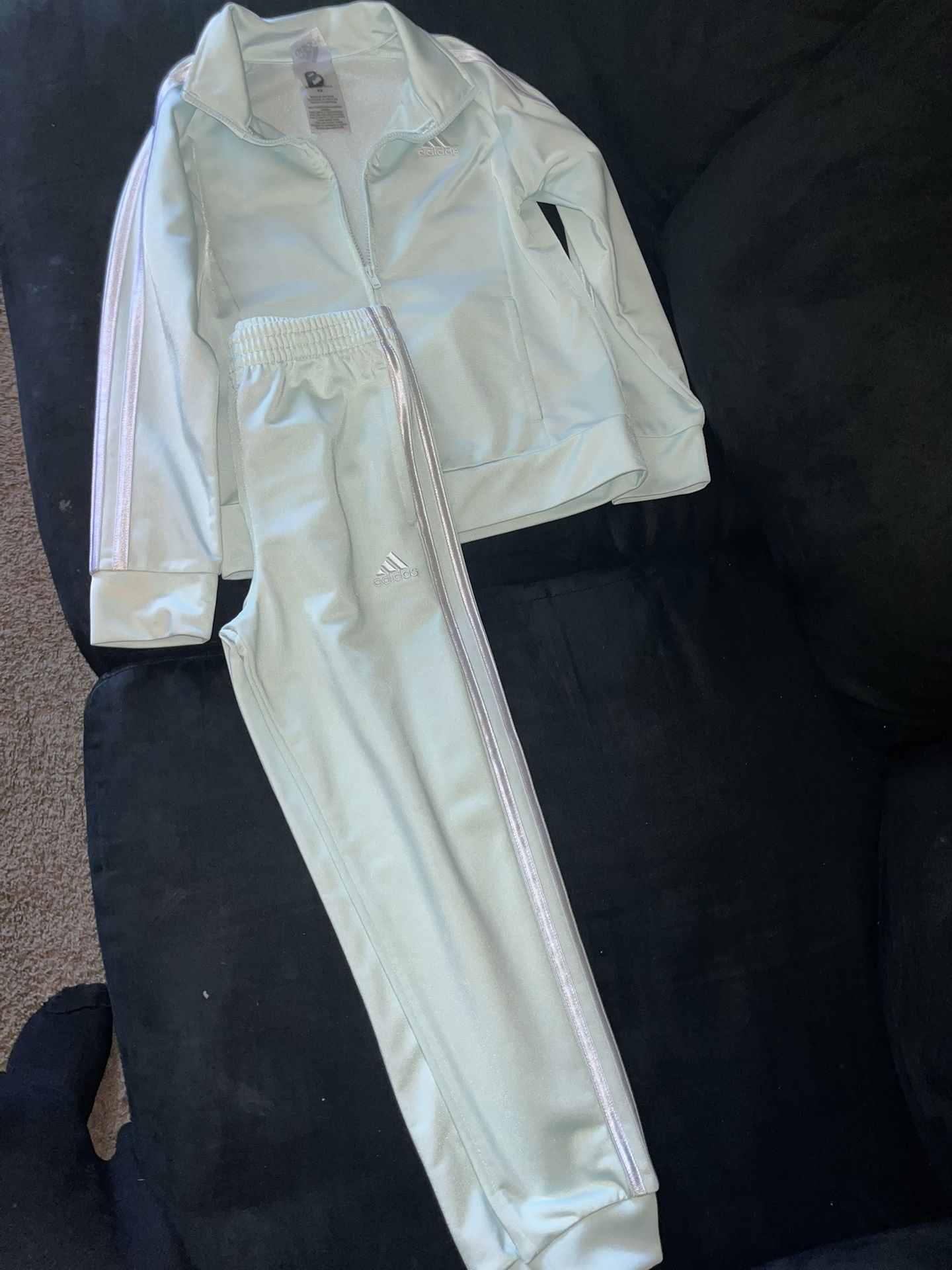 Adidas’s light green tracksuit, zip-up jacket and track pants,