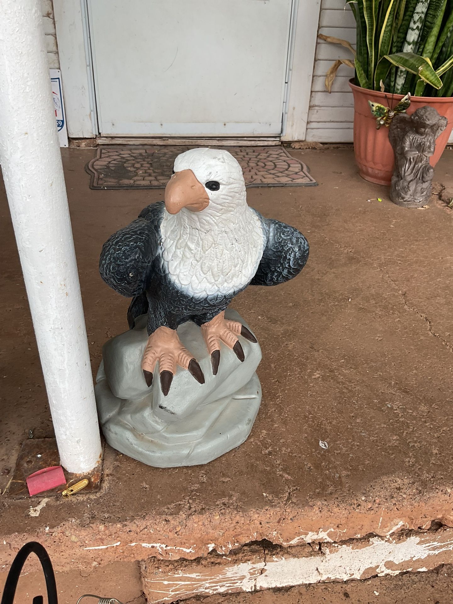A concrete eagle 19 inches tall
