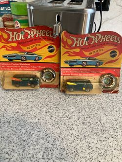 Too hot wheels vans with surfboards on the side.