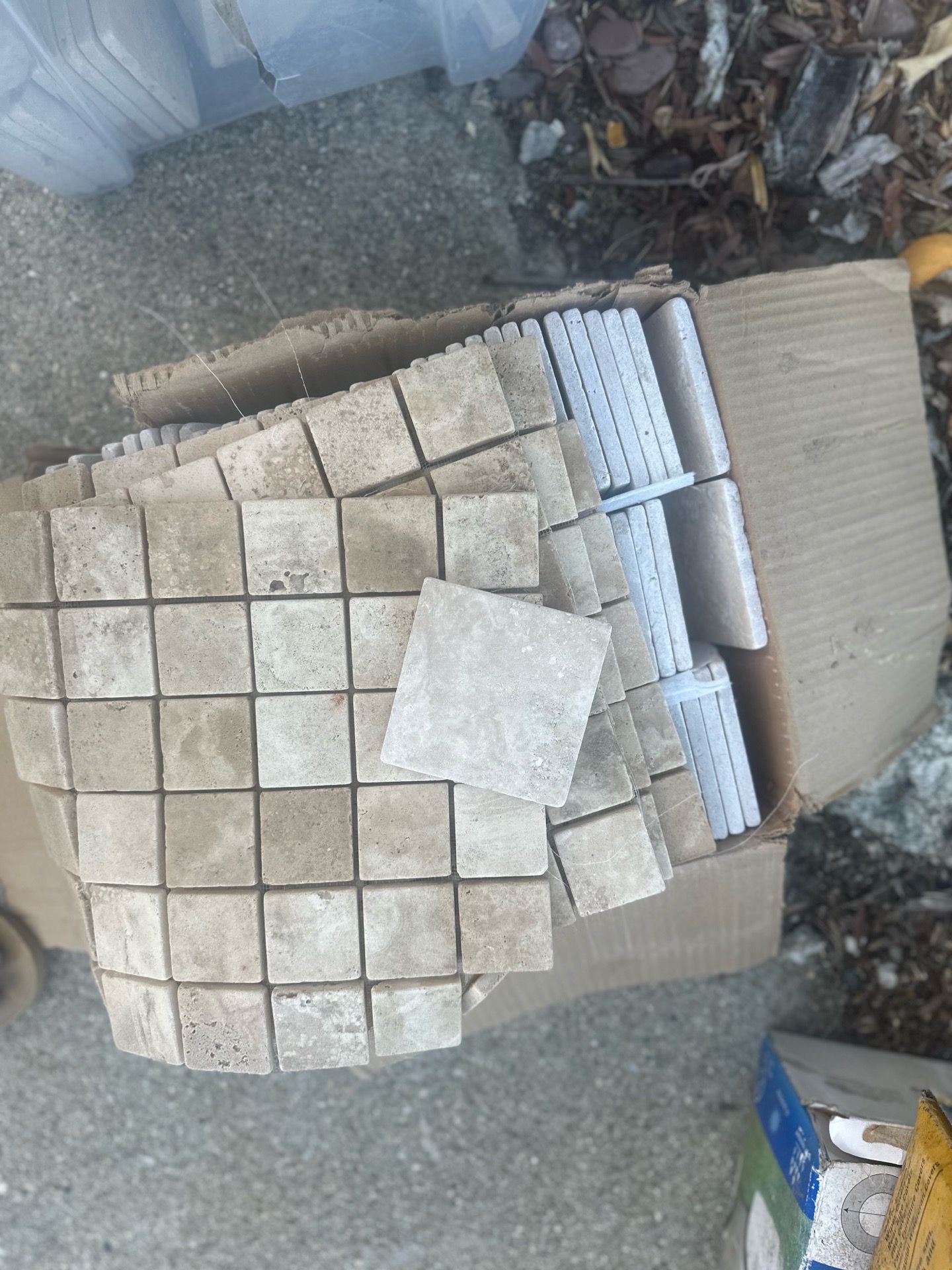 Assorted travertine tiles and pencils