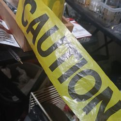 Yellow, plastic CAUTION tape.
