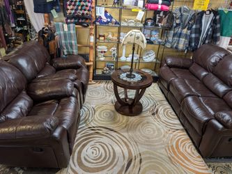 Three-Piece reclining faux leather couches, one three-seater and two reclining chairs delivery is extra at